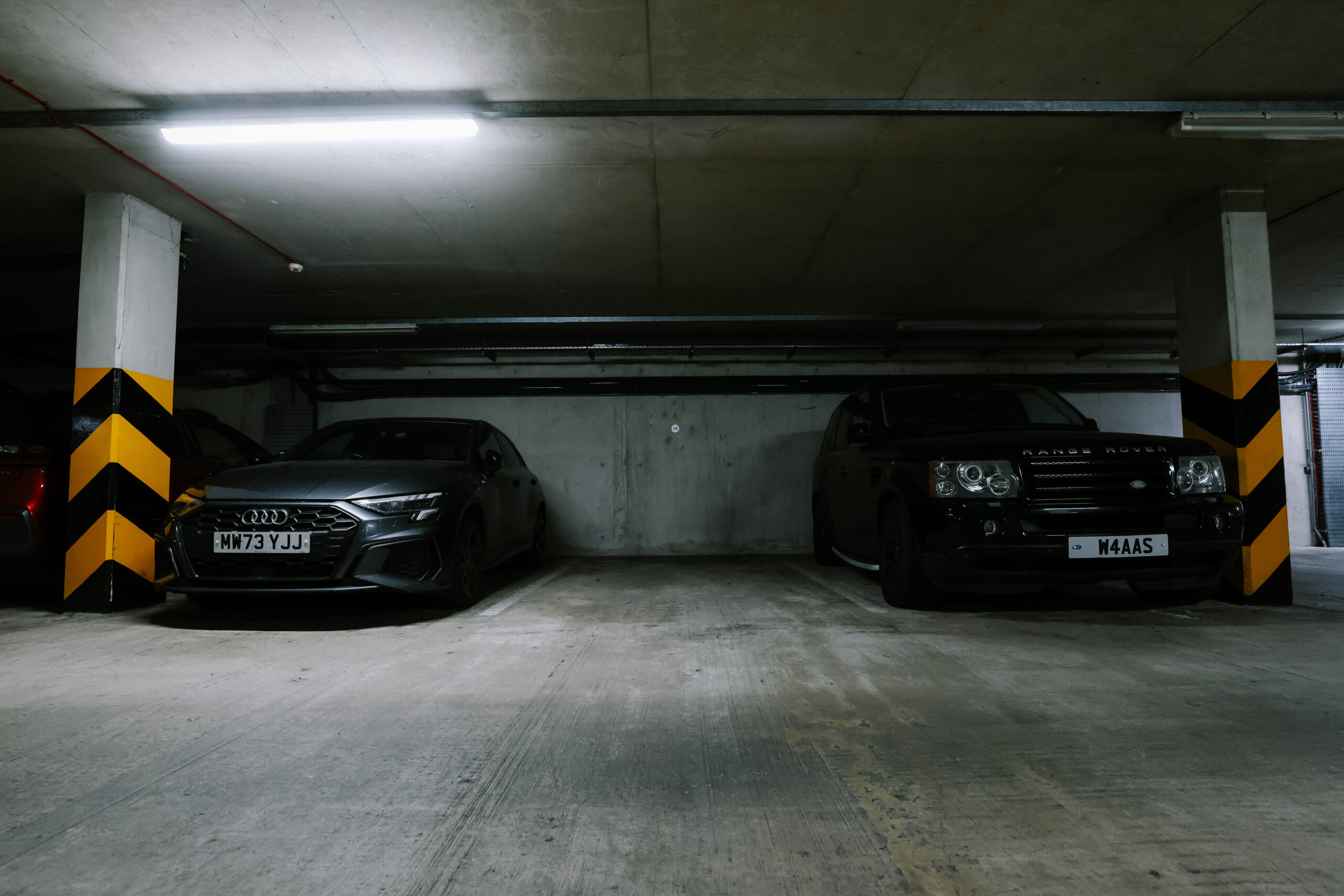 Secure underground car park at No.1 Deansgate with modern lighting and organised parking bays.