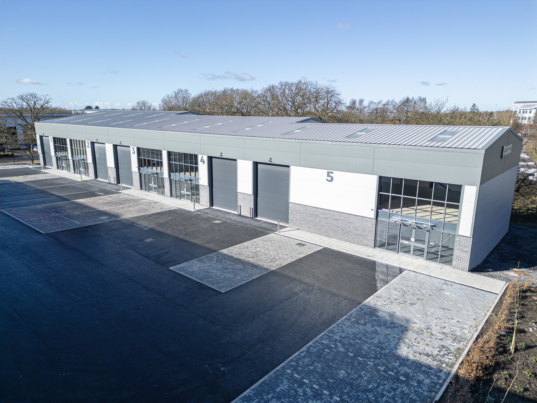 Row of modern industrial units and warehouses, ideal for businesses using LendFirst commercial bridging finance.